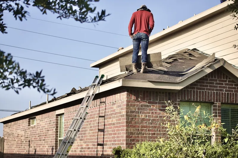 Professional roofer working on a residential roof in Cimarron Ridge